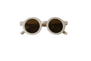Baby wearing Simplicity baby sunglasses in white, offering UV protection and timeless style